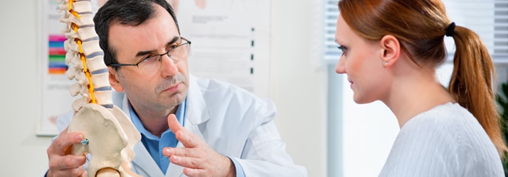 Chiropractor informing woman